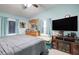 Relaxing bedroom with a ceiling fan, plush carpet, and a large flat-screen TV above a fireplace at 2619 Old Toney Rd, Ellenwood, GA 30294