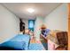 Modest bedroom with light blue walls, hardwood floors, bed, and assorted furniture and personal items at 2619 Old Toney Rd, Ellenwood, GA 30294
