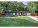 Charming single-story home with a well-maintained lawn, and a bright red front door at 2619 Old Toney Rd, Ellenwood, GA 30294