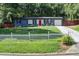 Charming home with a well-manicured front yard and a red front door at 2619 Old Toney Rd, Ellenwood, GA 30294