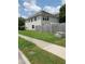 View of home's backyard with a wooden fence and green grass. A sidewalk runs adjacent to the property at 2748 Farmstead Ct, Grayson, GA 30017