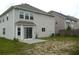 Exterior home view with sliding glass doors leading to a concrete patio and spacious backyard at 2748 Farmstead Ct, Grayson, GA 30017