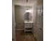 Cozy bathroom featuring wood-look floors, white vanity with drawers, and sleek black hardware at 2748 Farmstead Ct, Grayson, GA 30017