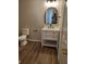 Stylish bathroom featuring a white vanity, updated light fixtures, and wood look floors at 2748 Farmstead Ct, Grayson, GA 30017