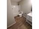 Bright bathroom featuring shower/tub combo, sleek vanity, and new wood floors at 2748 Farmstead Ct, Grayson, GA 30017