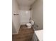 Bright bathroom featuring shower/tub combo, sleek vanity, and new wood floors at 2748 Farmstead Ct, Grayson, GA 30017