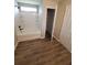 Bathroom featuring a tub with white tile surround and wood look floors at 2748 Farmstead Ct, Grayson, GA 30017
