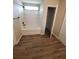 Bathroom featuring a tub with white tile surround and wood look floors at 2748 Farmstead Ct, Grayson, GA 30017