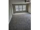 Spacious carpeted bedroom with bright natural light from windows at 2748 Farmstead Ct, Grayson, GA 30017
