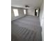 Spacious bedroom with plush gray carpet, ample natural light, and a ceiling fan at 2748 Farmstead Ct, Grayson, GA 30017