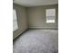 Carpeted bedroom with bright window and neutral-toned walls at 2748 Farmstead Ct, Grayson, GA 30017