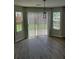 Bright dining room with wood floors, modern light fixture and sliding glass doors leading to a backyard at 2748 Farmstead Ct, Grayson, GA 30017