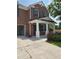 Two-story brick home featuring a covered front porch, an open two-car garage, and green landscaping at 2748 Farmstead Ct, Grayson, GA 30017