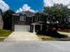 Charming brick two-story home featuring a two-car garage and a covered front porch at 2748 Farmstead Ct, Grayson, GA 30017