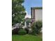 Side view of home's covered porch framed by lush bushes and a nearby street at 2748 Farmstead Ct, Grayson, GA 30017