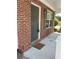 Welcoming front porch with brick detail, a 'Hey Y'all' doormat, and stylish exterior lighting at 2748 Farmstead Ct, Grayson, GA 30017