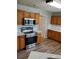 Kitchen featuring stainless steel appliances, wood cabinets, and white backsplash at 2748 Farmstead Ct, Grayson, GA 30017