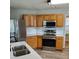 Well-lit kitchen with stainless steel appliances and double sink at 2748 Farmstead Ct, Grayson, GA 30017