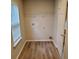 Laundry room features a window for natural light, and wood-look flooring at 2748 Farmstead Ct, Grayson, GA 30017