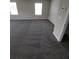 Spacious living room featuring two windows, gray carpet, and neutral wall paint at 2748 Farmstead Ct, Grayson, GA 30017