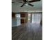An open living area featuring wood floors, natural light, and a ceiling fan at 2748 Farmstead Ct, Grayson, GA 30017