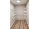 Walk-in closet features a wire shelving system, and wood-look flooring at 2748 Farmstead Ct, Grayson, GA 30017