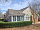 Charming tan and brick home featuring a beautiful sunroom and well-maintained landscaping at 2730 Vintage Reserve Ln, Marietta, GA 30066