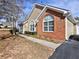 Charming home exterior with brick accents, manicured bushes, and a welcoming driveway at 2730 Vintage Reserve Ln, Marietta, GA 30066