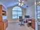 Well-lit home office with a desk, storage, and a large arched window for a productive workspace at 2730 Vintage Reserve Ln, Marietta, GA 30066