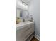 Bathroom featuring a modern vanity with drawers, a decorative mirror, and stylish lighting at 2886 Webb Bridge Rd, Alpharetta, GA 30009