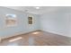 Spacious bedroom with wood-look flooring, natural light, and ample space for relaxation at 2886 Webb Bridge Rd, Alpharetta, GA 30009