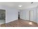 Bedroom with wood-look flooring, closet and doorway leading to a bathroom with a glass-enclosed shower at 2886 Webb Bridge Rd, Alpharetta, GA 30009