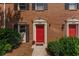 Charming townhome with a striking red front door and well-maintained landscaping at 2886 Webb Bridge Rd, Alpharetta, GA 30009