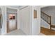 Hallway shows new vinyl flooring and doors leading to a living area and a staircase at 2886 Webb Bridge Rd, Alpharetta, GA 30009