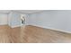 Bright living room with wood-look flooring leading to the kitchen, creating an inviting and open atmosphere at 2886 Webb Bridge Rd, Alpharetta, GA 30009