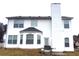 Exterior view of a house highlighting the spacious backyard and architectural details at 4232 Kensington Cv, Atlanta, GA 30349