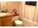Cozy bathroom features a shower tub combo, toilet, and vanity with cabinet at 4232 Kensington Cv, Atlanta, GA 30349