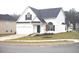 Charming two-story home featuring a manicured lawn and attached two car garage, offering both curb appeal and convenience at 4232 Kensington Cv, Atlanta, GA 30349