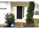 Inviting front entryway featuring a black front door, stylish sidelight, and secure ADT security system for peace of mind at 4232 Kensington Cv, Atlanta, GA 30349