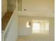 Spacious living room with a view of the staircase, chandelier, and large window, offering a bright and airy space at 4232 Kensington Cv, Atlanta, GA 30349