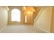 Bright living room boasting large windows, plush carpeting, and staircase, creating a warm and welcoming atmosphere at 4232 Kensington Cv, Atlanta, GA 30349