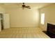 Large living room with fireplace, ceiling fan and neutral carpet, featuring a comfortable and versatile living space at 4232 Kensington Cv, Atlanta, GA 30349