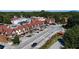 Aerial view showcases walkable community and unique Tudor architecture near lush trees and Stone Mountain in the background at 613 Harrington Hls, Decatur, GA 30032