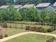 Well-manicured backyard with a secure black fence, lush greenery, and a stone staircase adding charm to the outdoor space at 613 Harrington Hls, Decatur, GA 30032