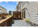 This backyard patio features gray tiles, natural wood seating, and exterior access to the home at 613 Harrington Hls, Decatur, GA 30032
