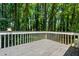 A backyard wooden deck featuring green tree views at 1131 Hershey Dr, Marietta, GA 30062