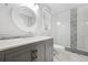 Modern bathroom with a glass shower and vanity with granite countertop and storage at 1131 Hershey Dr, Marietta, GA 30062