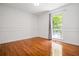 Bright bedroom with hardwood floors, white walls, and a large window with a view of the trees at 1131 Hershey Dr, Marietta, GA 30062