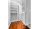 Walk-in closet with custom white shelving, drawers, and wood flooring at 1131 Hershey Dr, Marietta, GA 30062