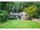 Charming single-Gathering home with a well-manicured lawn and mature trees at 1131 Hershey Dr, Marietta, GA 30062